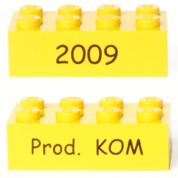 Brick 2 x 4 with Black '2009' and 'Prod. KOM' Pattern on Opposite Sides (Kornmarken Factory Tour) - Yellow Brick 2 x 4 with Black '2009' and 'Prod. KOM' Pattern on Opposite Sides (Kornmarken Factory Tour) - Yellow