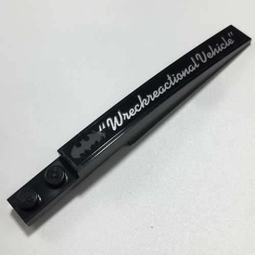 Деталь LEGO 85970pb029L Slope, Curved 10 x 1 with Dark Bluish Gray Batman Logo and Silver 'Wreckreactional Vehicle' Pattern Model Left Side Pattern (Sticker) - Set 70917