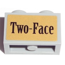 Technic, Brick 1 x 2 with Axle Hole with Black 'Two-Face' on Gold Background Pattern (Sticker) - Set 7785 Technic, Brick 1 x 2 with Axle Hole with Black 'Two-Face' on Gold Background Pattern (Sticker) - Set 7785