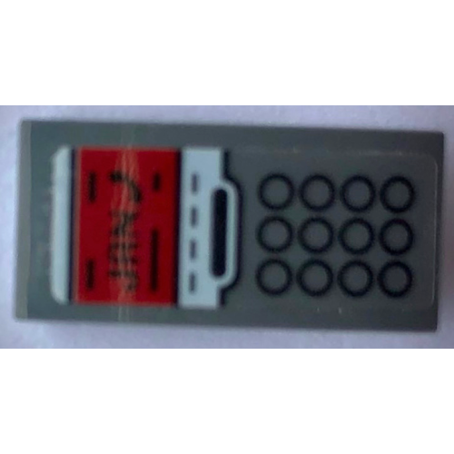 Деталь LEGO 11477pb169 Slope, Curved 2 x 1 x 2/3 with Telephone with 12 Black Circles Keypad and Red Screen with 'JAN' Pattern (Sticker) - Set 21336